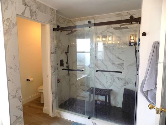Bathroom, Glass Shower, Interior, Marble Walls, Wood Texture Flooring