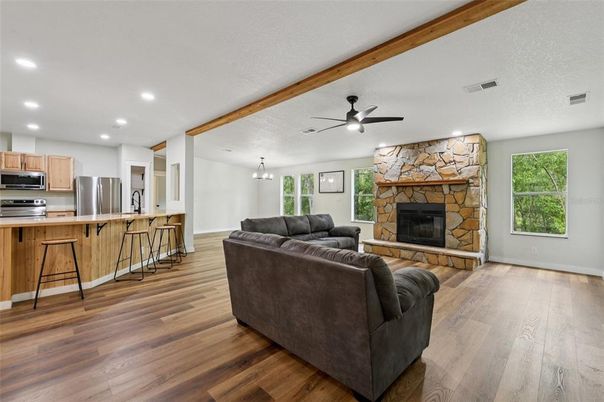 Fireplace, Interior, Kitchen, Living room, Recessed Lighting, Stainless Steel Appliances, Stone Walls, Wood Texture Flooring