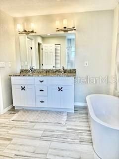 Bathroom, Dual Sink Vanities, Free Standing Baths, Interior, Marble, Recessed Lighting, Wood Texture Flooring