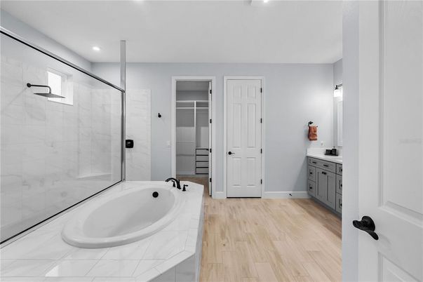 Bathroom, Glass Shower, Interior, Recessed Lighting, Tile Countertops, Wood Texture Flooring
