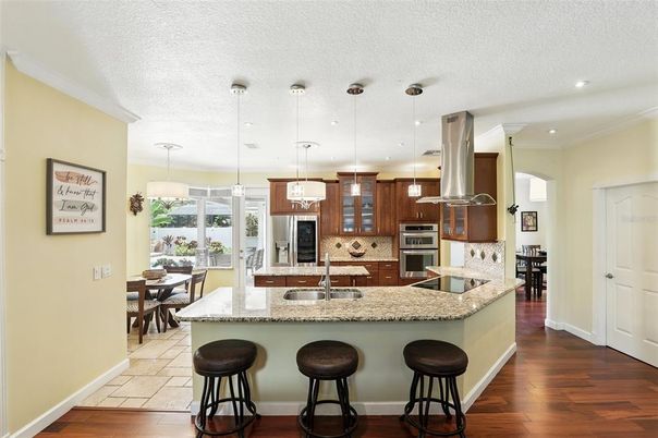 Dining room, Interior, Kitchen, Pendant Lights, Recessed Lighting, Stainless Steel Appliances, Wood Texture Flooring