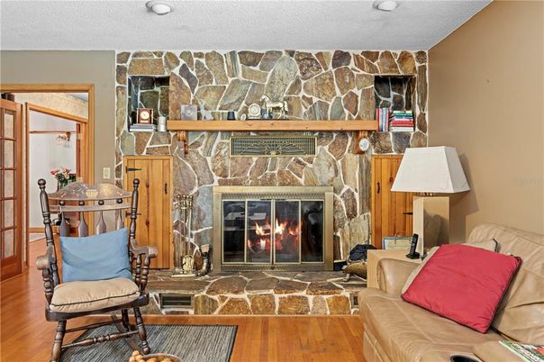 Fireplace, Interior, Living room, Recessed Lighting, Stone Walls, Wood Texture Flooring