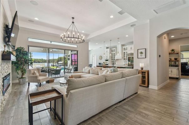 Chandelier, Fireplace, Interior, Kitchen, Living room, Pendant Lights, Recessed Lighting, Wood Texture Flooring