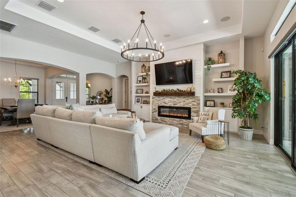 Chandelier, Dining room, Fireplace, Interior, Living room, Pendant Lights, Recessed Lighting, Wood Texture Flooring