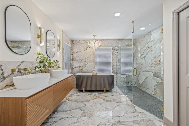Bathroom, Chandelier, Dual Sink Vanities, Free Standing Baths, Glass Shower, Interior, Marble Walls, Recessed Lighting