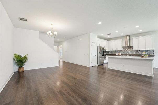 Chandelier, Empty room, Interior, Kitchen, Recessed Lighting, Stainless Steel Appliances, Wood Texture Flooring