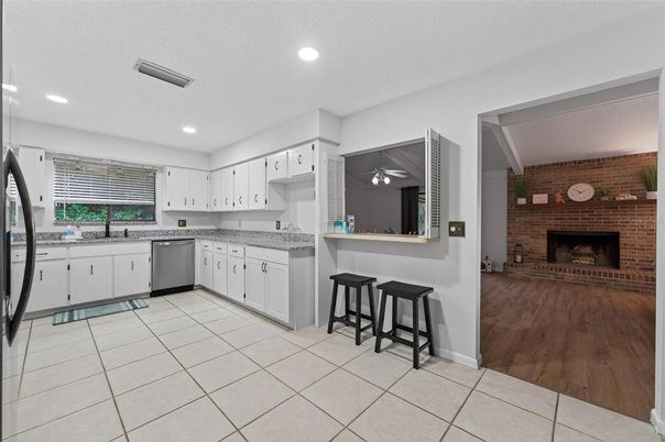 Fireplace, Interior, Kitchen, Recessed Lighting, Stainless Steel Appliances, Stone Walls, Wood Texture Flooring
