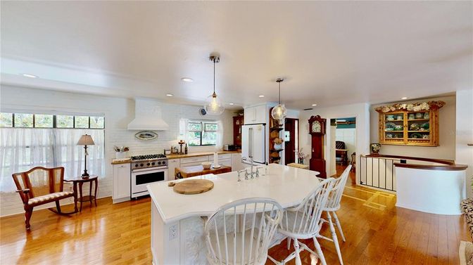 Fireplace, Interior, Kitchen, Pendant Lights, Recessed Lighting, Stainless Steel Appliances, Stone Walls, Wood Texture Flooring