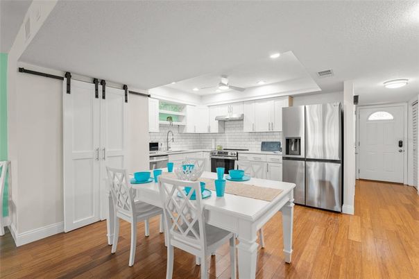 Dining room, Interior, Kitchen, Recessed Lighting, Stainless Steel Appliances, Wood Texture Flooring