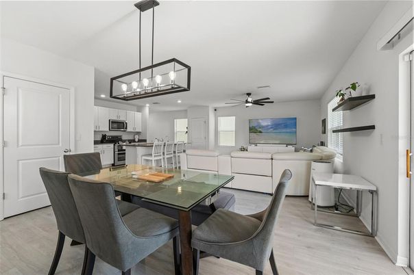 Chandelier, Dining room, Interior, Kitchen, Living room, Pendant Lights, Recessed Lighting, Stainless Steel Appliances, Wood Texture Flooring