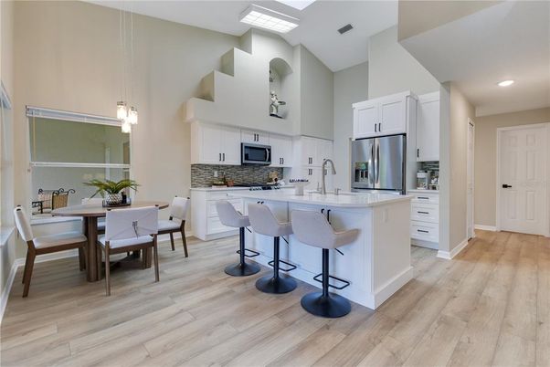 Dining room, Interior, Kitchen, Pendant Lights, Recessed Lighting, Stainless Steel Appliances, Wood Texture Flooring