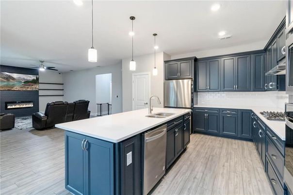 Fireplace, Interior, Kitchen, Living room, Pendant Lights, Recessed Lighting, Stainless Steel Appliances, Wood Texture Flooring