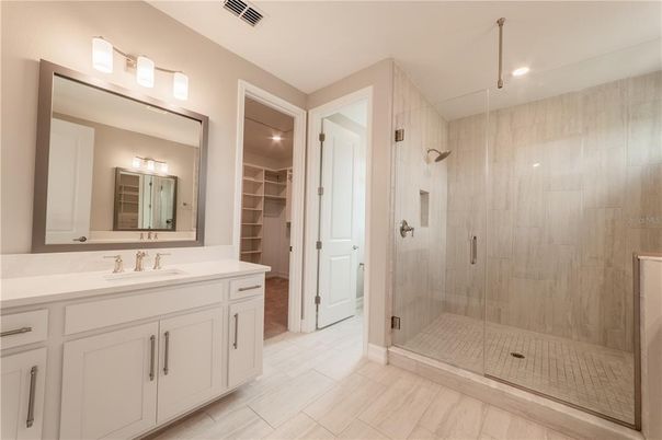 Bathroom, Dual Sink Vanities, Glass Shower, Interior, Recessed Lighting, Walk-in Closets, Wood Texture Flooring