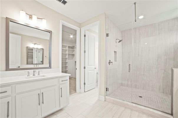 Bathroom, Dual Sink Vanities, Glass Shower, Interior, Recessed Lighting, Walk-in Closets, Wood Texture Flooring
