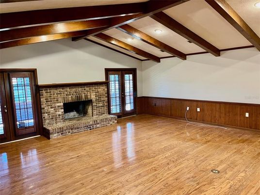 Empty room, Fireplace, Interior, Recessed Lighting, Stone Walls, Wooden Beams, Wood Texture Flooring