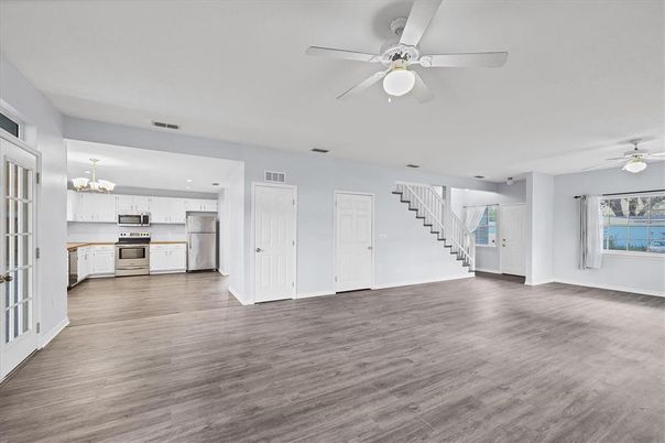 Chandelier, Empty room, Interior, Kitchen, Recessed Lighting, Stainless Steel Appliances, Wood Texture Flooring