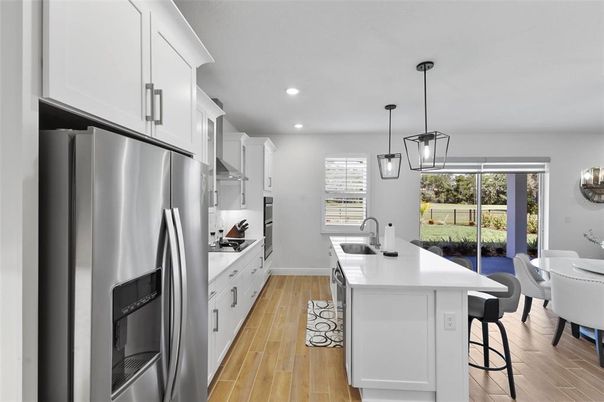 Dining room, Interior, Kitchen, Pendant Lights, Recessed Lighting, Stainless Steel Appliances, Wood Texture Flooring