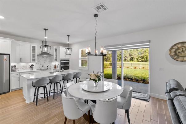 Chandelier, Dining room, Interior, Kitchen, Pendant Lights, Recessed Lighting, Stainless Steel Appliances, Wood Texture Flooring