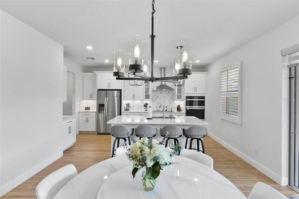 Dining room, Interior, Kitchen, Pendant Lights, Recessed Lighting, Stainless Steel Appliances, Wood Texture Flooring