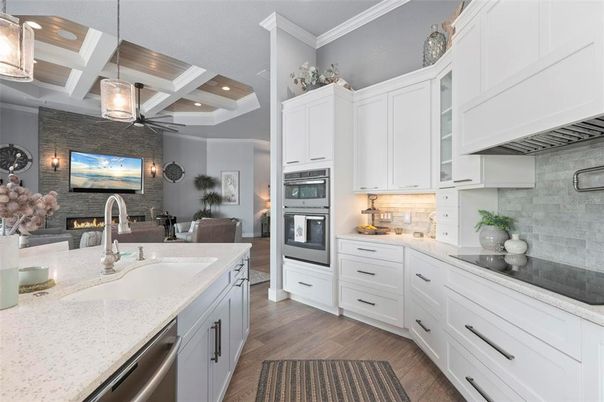 Fireplace, Interior, Kitchen, Living room, Pendant Lights, Recessed Lighting, Stainless Steel Appliances, Stone Walls, Wood Texture Flooring