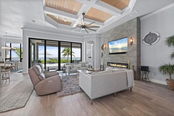 Dining room, Fireplace, Interior, Living room, Pendant Lights, Stone Walls, Water, Wood Texture Flooring