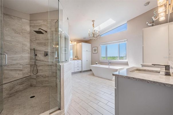 Bathroom, Chandelier, Dual Sink Vanities, Free Standing Baths, Glass Shower, Interior, Marble Walls
