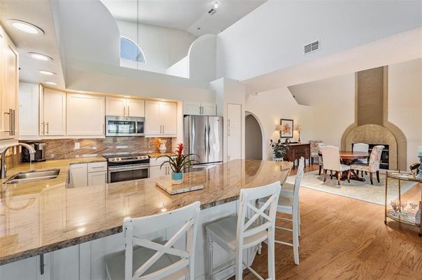 Dining room, Fireplace, Interior, Kitchen, Pendant Lights, Recessed Lighting, Stainless Steel Appliances, Wood Texture Flooring