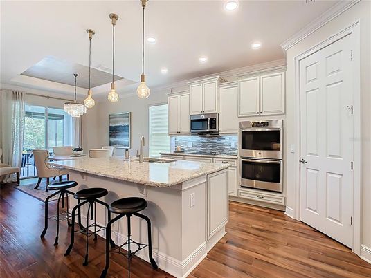 Dining room, Interior, Kitchen, Pendant Lights, Recessed Lighting, Stainless Steel Appliances, Wood Texture Flooring