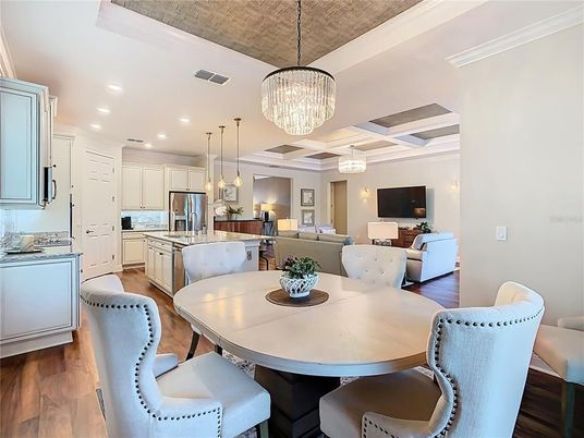 Chandelier, Dining room, Interior, Kitchen, Living room, Pendant Lights, Recessed Lighting, Stainless Steel Appliances, Wood Texture Flooring