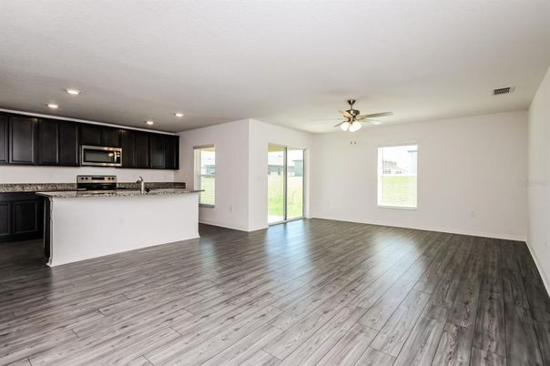Empty room, Interior, Kitchen, Recessed Lighting, Stainless Steel Appliances, Wood Texture Flooring