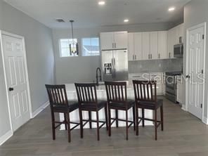 Chandelier, Interior, Kitchen, Pendant Lights, Recessed Lighting, Stainless Steel Appliances, Wood Texture Flooring
