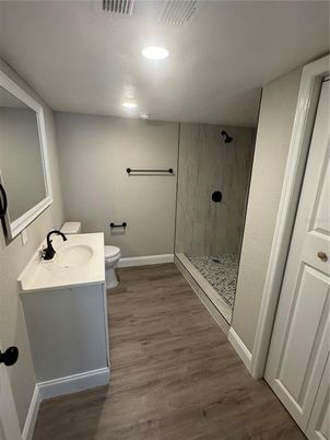 Bathroom, Glass Shower, Interior, Marble Walls, Recessed Lighting, Wood Texture Flooring