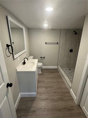 Bathroom, Glass Shower, Interior, Marble Walls, Recessed Lighting, Wood Texture Flooring