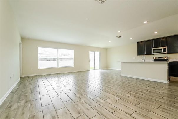 Empty room, Interior, Kitchen, Recessed Lighting, Stainless Steel Appliances, Wood Texture Flooring