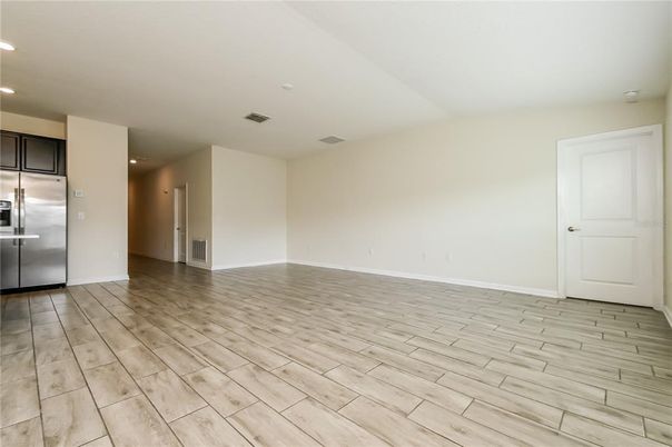 Empty room, Interior, Kitchen, Recessed Lighting, Stainless Steel Appliances, Wood Texture Flooring