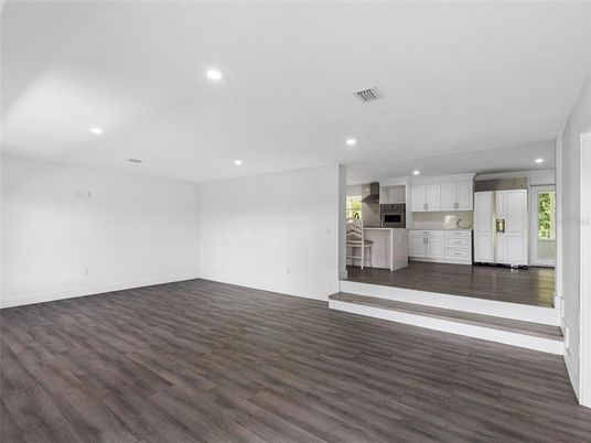 Empty room, Interior, Kitchen, Recessed Lighting, Stainless Steel Appliances, Wood Texture Flooring