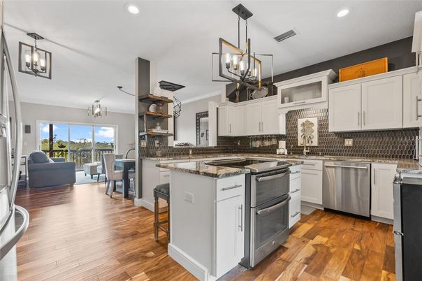Dining room, Interior, Kitchen, Pendant Lights, Recessed Lighting, Stainless Steel Appliances, Wood Texture Flooring