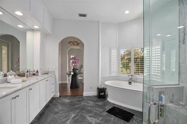 Bathroom, Dual Sink Vanities, Free Standing Baths, Glass Shower, Interior, Marble, Marble Walls, Recessed Lighting, Wood Texture Flooring