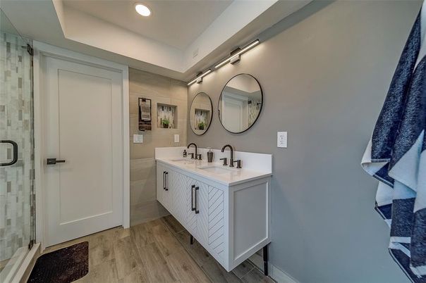 Bathroom, Dual Sink Vanities, Glass Shower, Interior, Recessed Lighting, Wood Texture Flooring