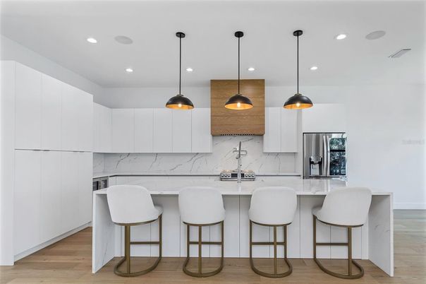 Interior, Kitchen, Marble Walls, Pendant Lights, Recessed Lighting, Stainless Steel Appliances, Wood Texture Flooring