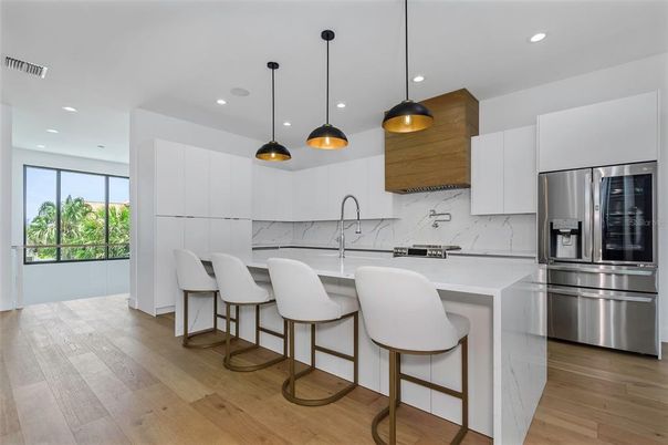 Interior, Kitchen, Marble Walls, Pendant Lights, Recessed Lighting, Stainless Steel Appliances, Wood Texture Flooring