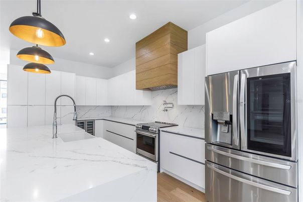 Interior, Kitchen, Marble Walls, Recessed Lighting, Stainless Steel Appliances, Wood Texture Flooring
