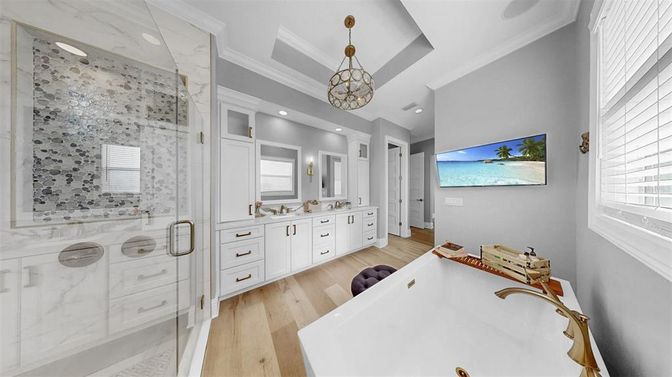 Bathroom, Dual Sink Vanities, Glass Shower, Interior, Marble Walls, Pendant Lights, Recessed Lighting, Wood Texture Flooring