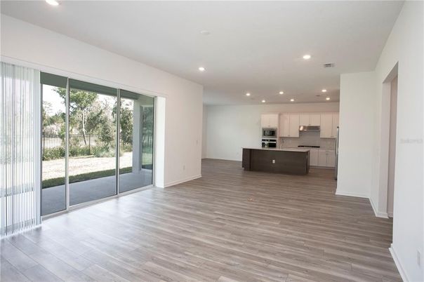 Empty room, Interior, Kitchen, Recessed Lighting, Stainless Steel Appliances, Wood Texture Flooring