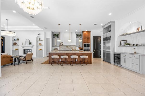Chandelier, Fireplace, Interior, Kitchen, Living room, Pendant Lights, Recessed Lighting, Stainless Steel Appliances