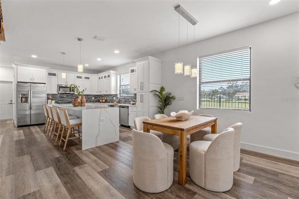 Dining room, Interior, Kitchen, Pendant Lights, Recessed Lighting, Stainless Steel Appliances, Wood Texture Flooring