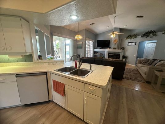 Chandelier, Fireplace, Interior, Kitchen, Living room, Pendant Lights, Recessed Lighting, Wood Texture Flooring