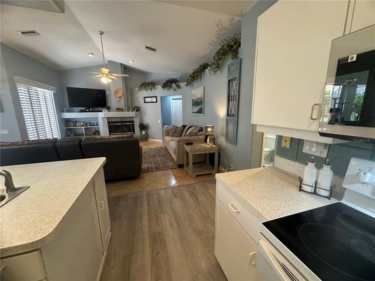 Fireplace, Interior, Kitchen, Living room, Recessed Lighting, Wood Texture Flooring