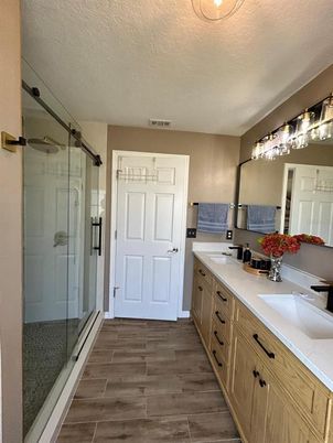 Bathroom, Dual Sink Vanities, Glass Shower, Interior, Wood Texture Flooring