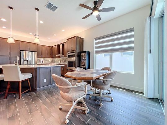 Dining room, Interior, Kitchen, Pendant Lights, Recessed Lighting, Stainless Steel Appliances, Wood Texture Flooring